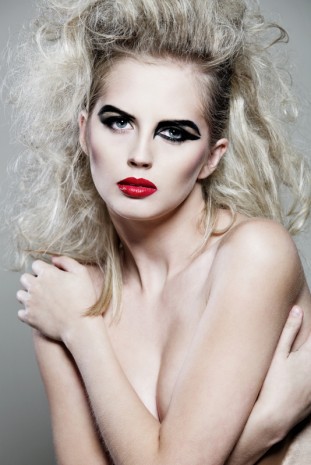 Female model with long curly hair.